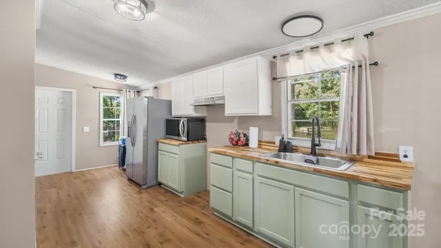 a kitchen with a refrigerator and a stove top oven