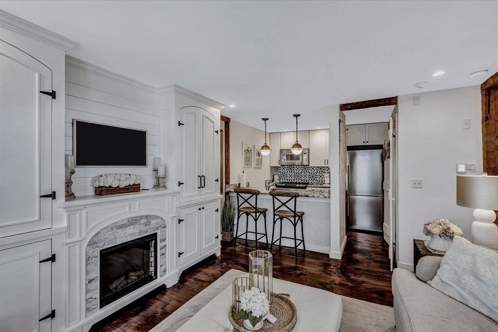 21 Milestone Way, Unit 620 Mashpee, MA 02649 - Photo 7 of 28 a living room with furniture a fireplace and a flat screen tv