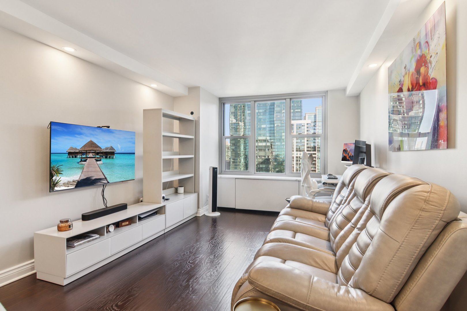 400 East Randolph Street, Unit 3714 Chicago, IL 60601 - Photo 2 of 23 a living room with furniture gym equipment and a large window