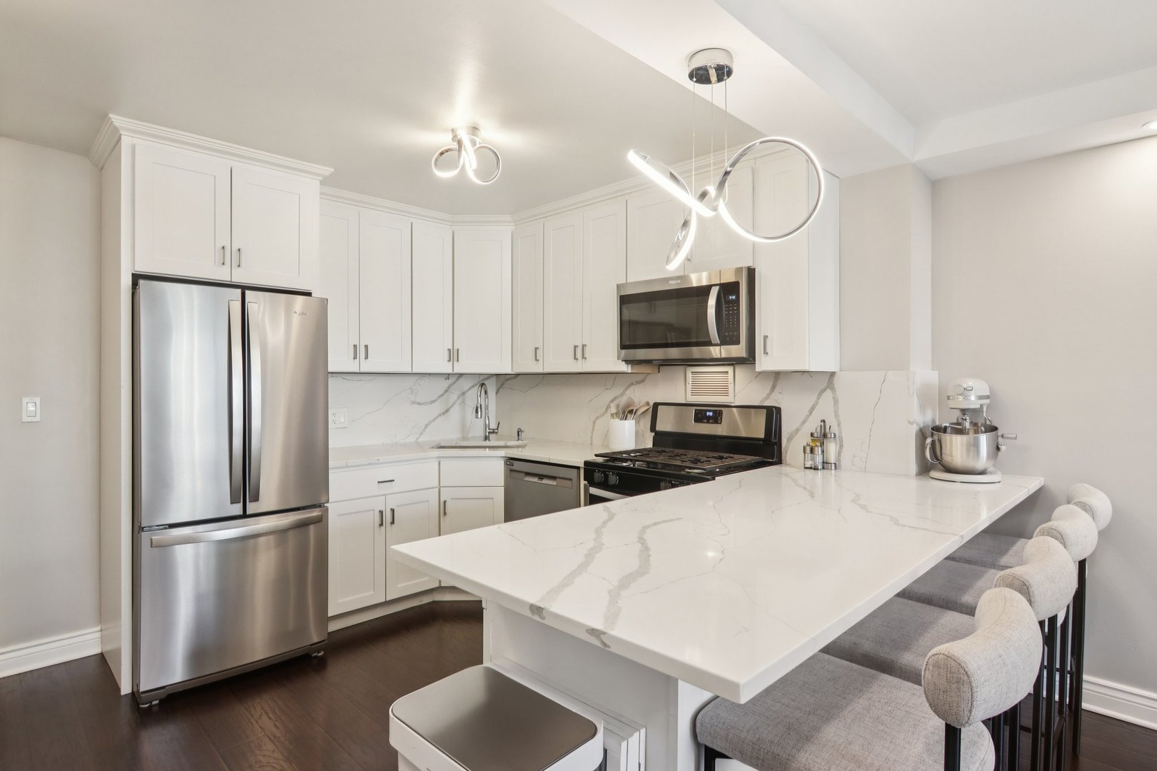400 East Randolph Street, Unit 3714 Chicago, IL 60601 - Photo 4 of 23 a kitchen with a refrigerator a stove a sink and a microwave