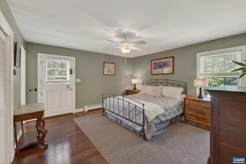a spacious bedroom with a bed and a cabinets