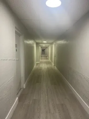 a view of hallway with an empty room