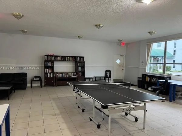 a living room with furniture pool table and a fireplace