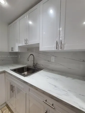 a kitchen with a sink and cabinets