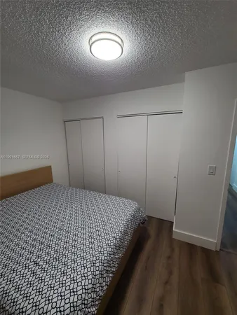 a bedroom with a bed and a mirror