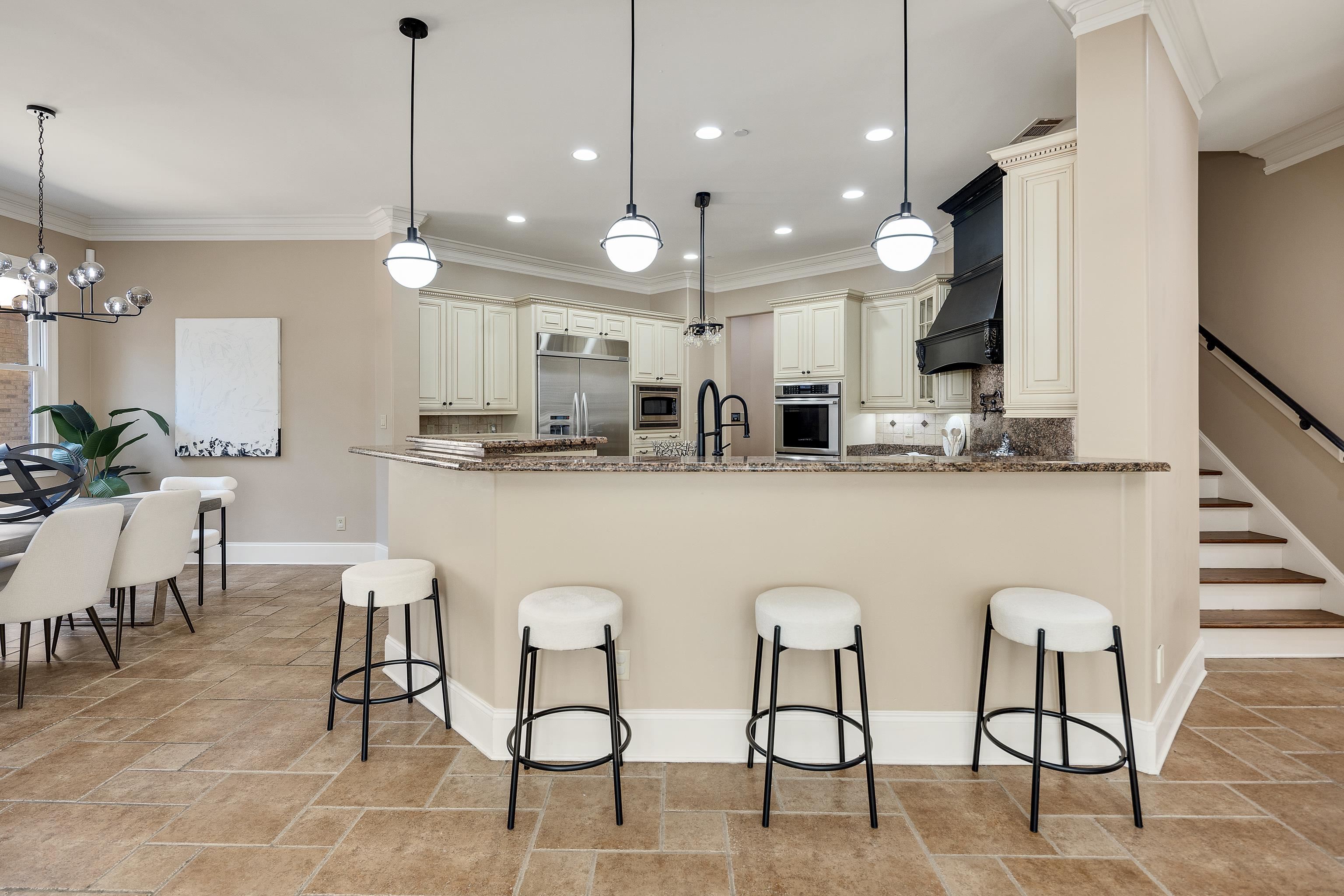 425 Buckland Cove Eads, TN 38028 - Photo 12 of 29 Kitchen with backsplash, hanging light fixtures, crown molding, a peninsula, and a kitchen breakfast bar