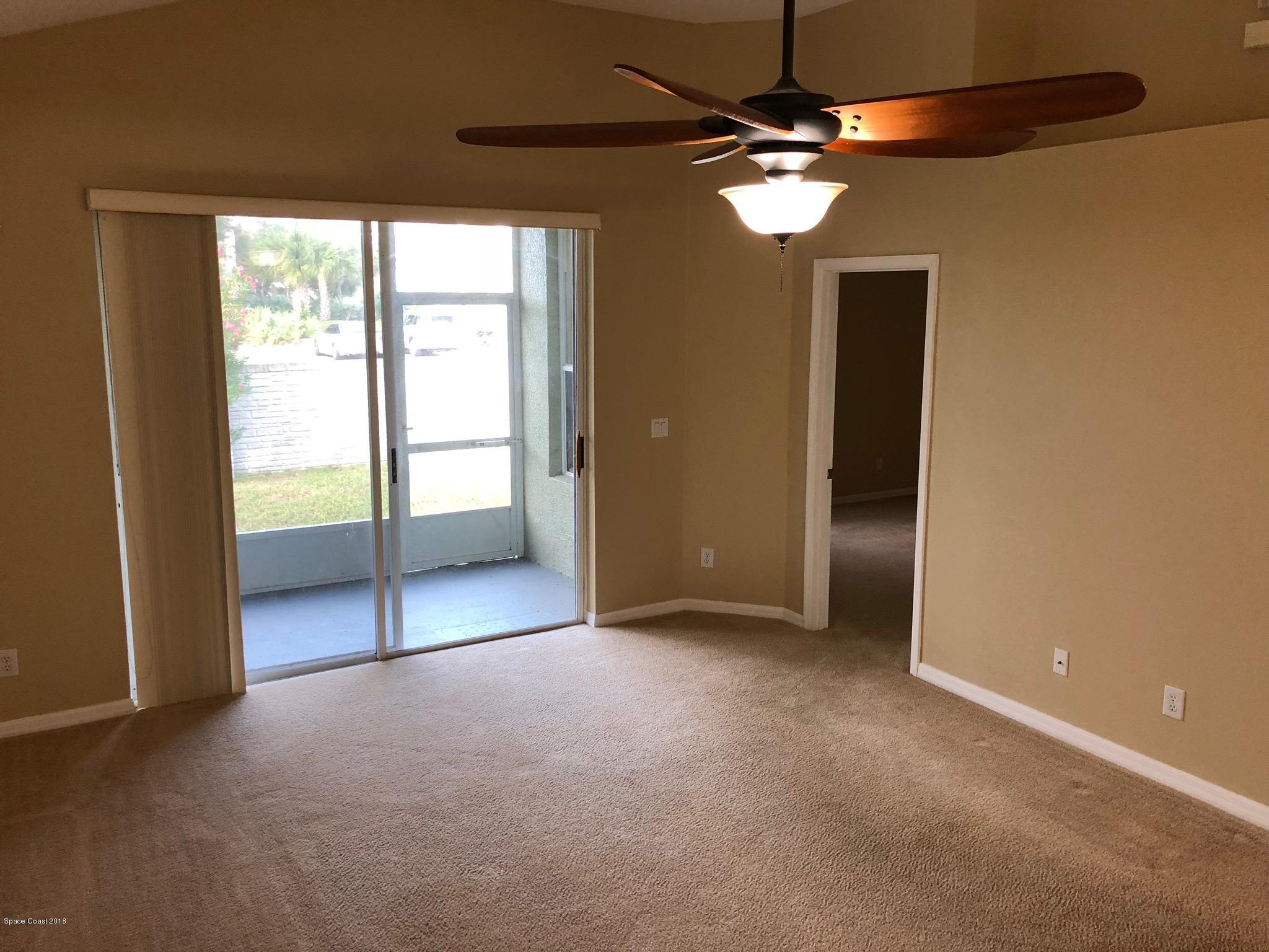 314 Intrepid Way Melbourne, FL 32903 - Photo 12 of 31 an empty room with chandelier fan