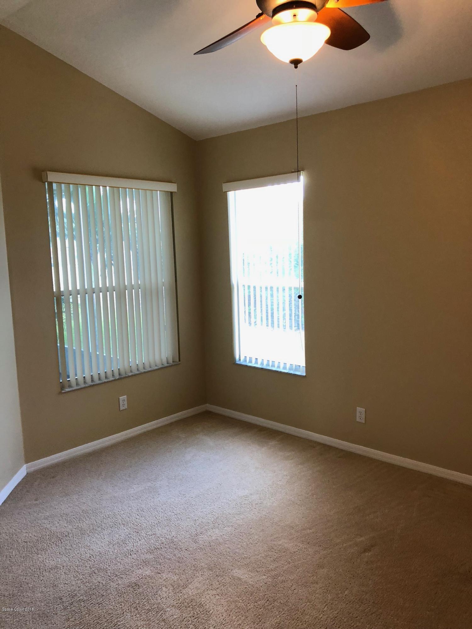 314 Intrepid Way Melbourne, FL 32903 - Photo 19 of 31 an empty room with windows and fan