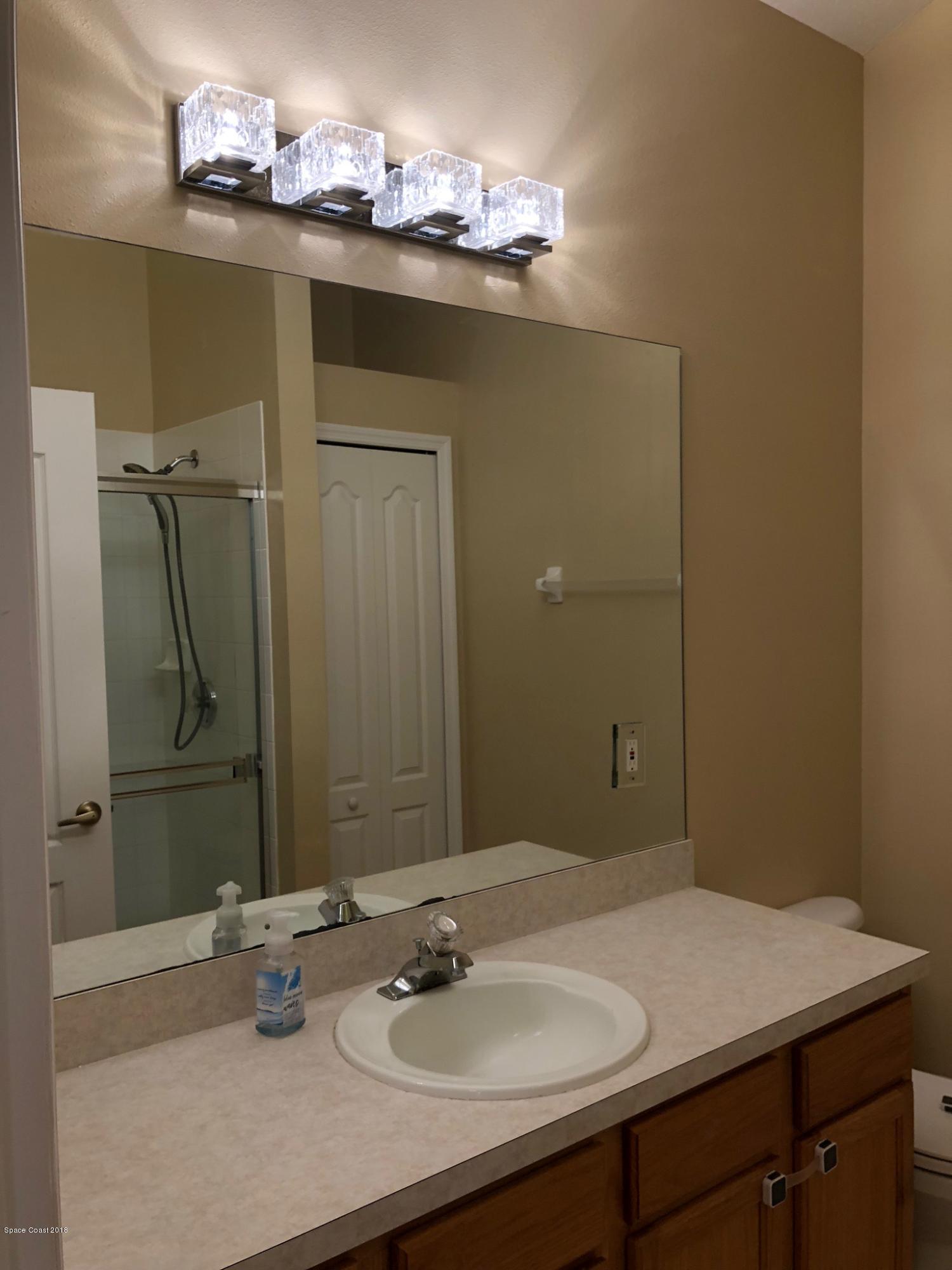 314 Intrepid Way Melbourne, FL 32903 - Photo 21 of 31 a bathroom with a sink vanity and a mirror