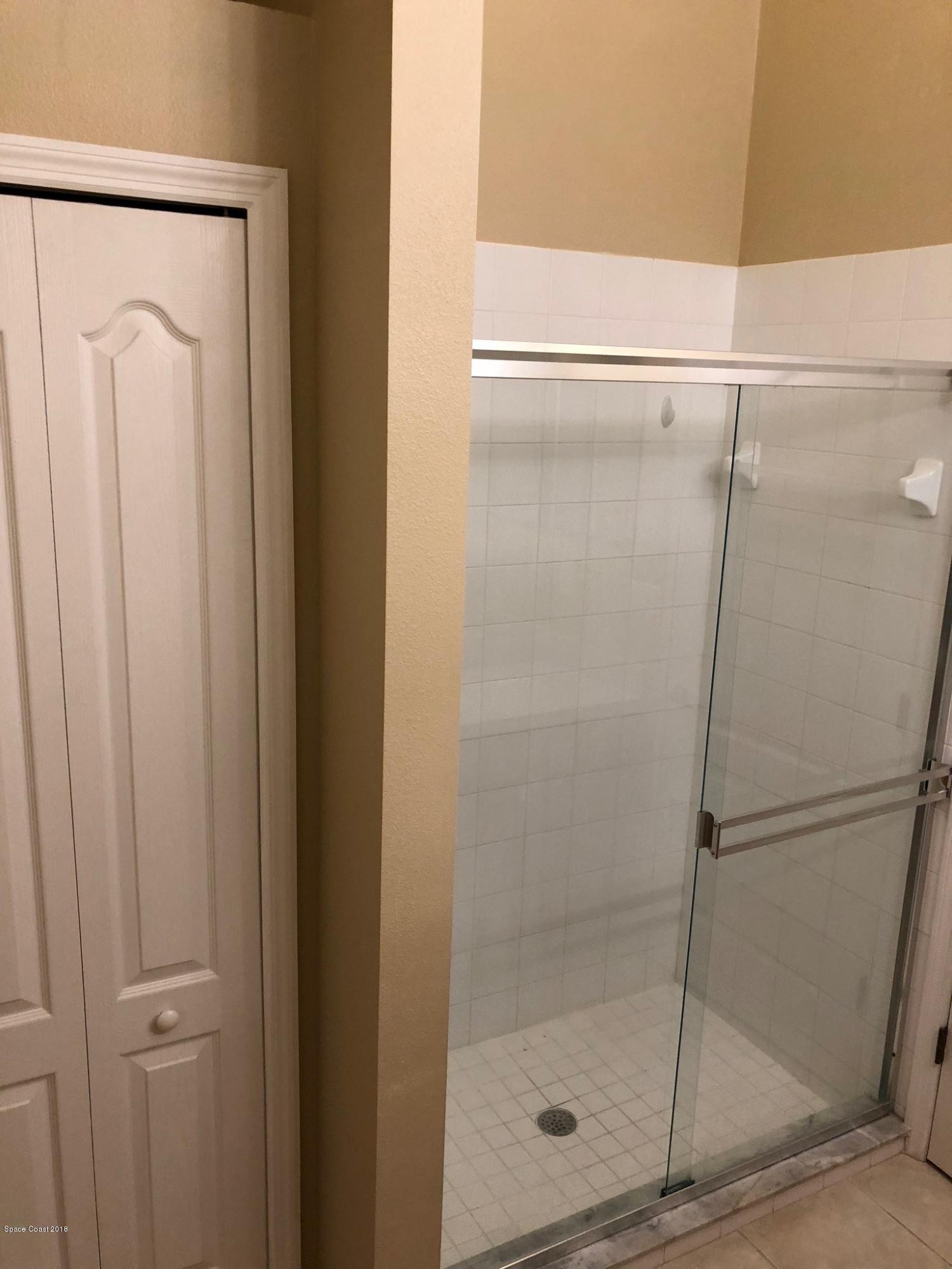 314 Intrepid Way Melbourne, FL 32903 - Photo 22 of 31 a bathroom with a glass shower door