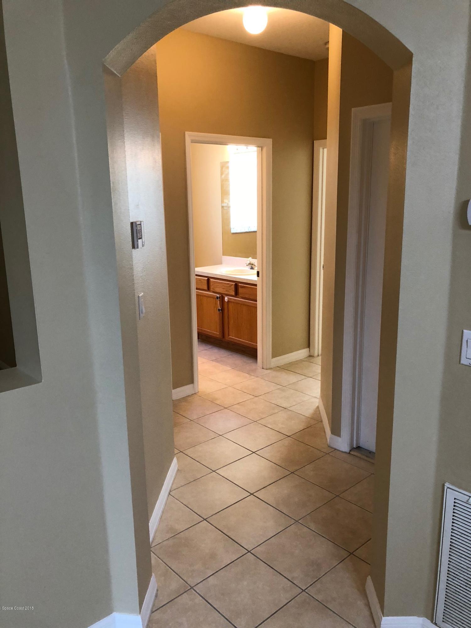 314 Intrepid Way Melbourne, FL 32903 - Photo 24 of 31 a en suite bathroom with a sink and a mirror