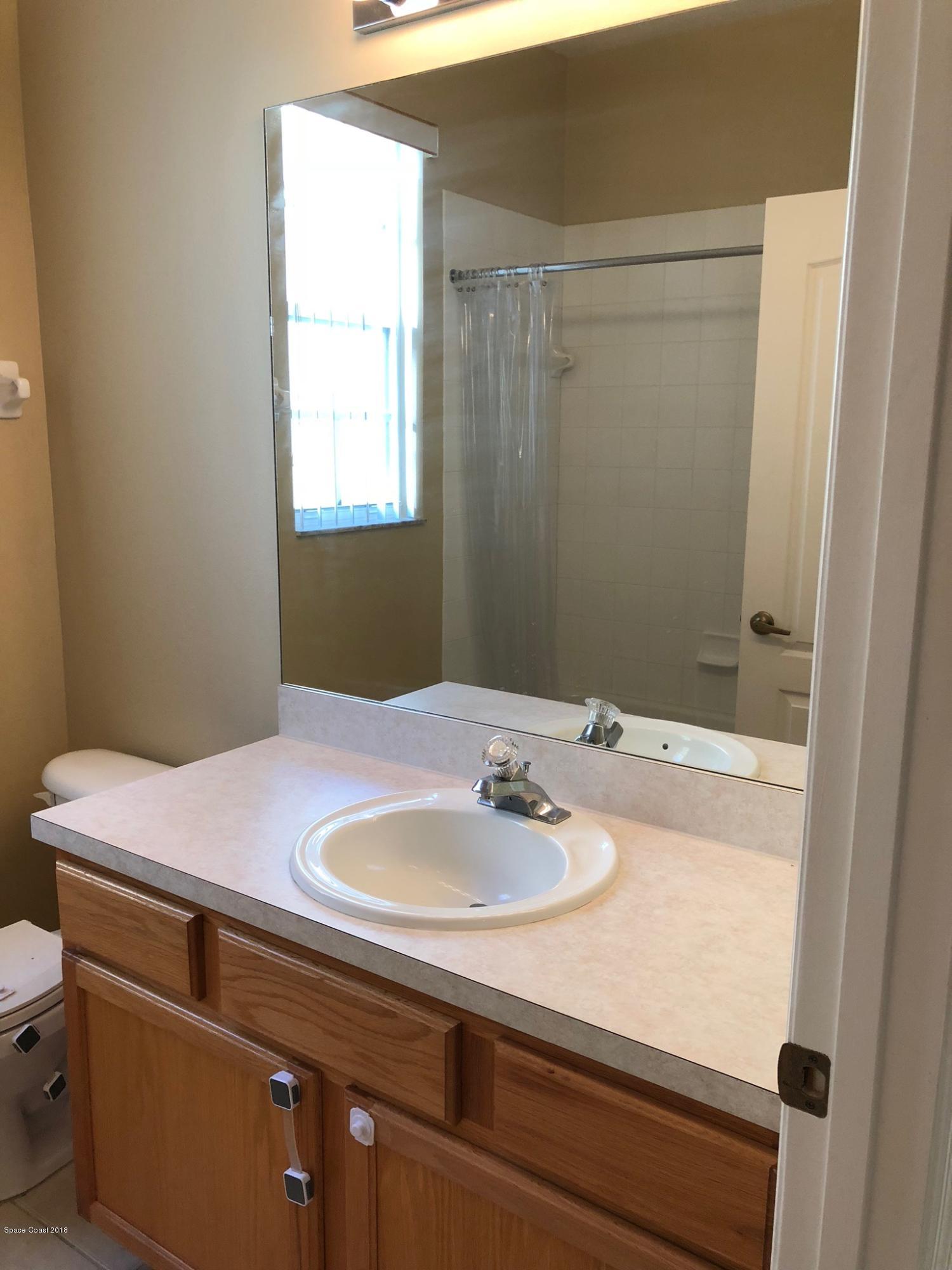 314 Intrepid Way Melbourne, FL 32903 - Photo 26 of 31 a bathroom with a sink and a mirror