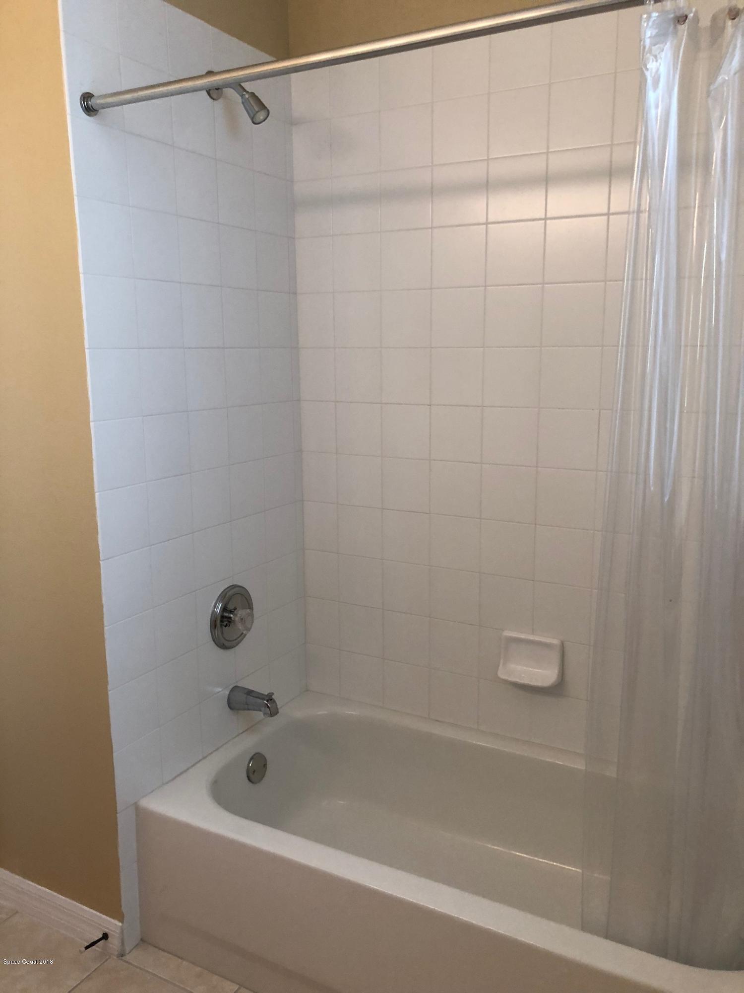 314 Intrepid Way Melbourne, FL 32903 - Photo 27 of 31 a bathroom with a shower and a bath tub