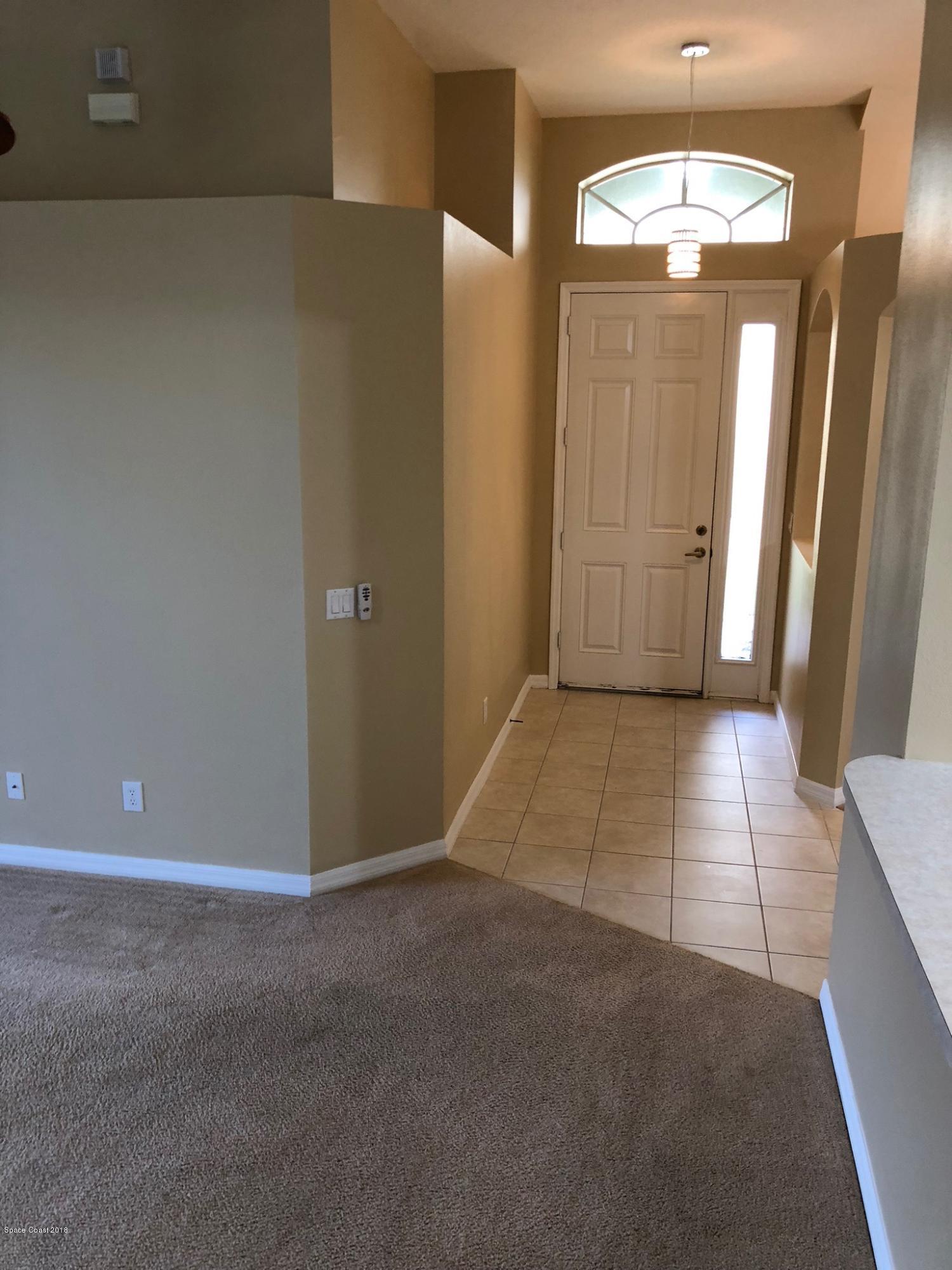 314 Intrepid Way Melbourne, FL 32903 - Photo 4 of 31 an empty room with wooden floor and windows