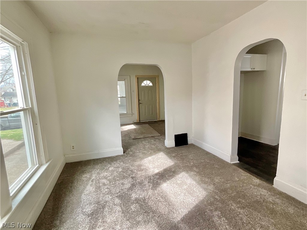 425 Spaulding Street Akron, OH 44310 - Photo 4 of 17 Carpeted spare room with baseboards and arched walkways