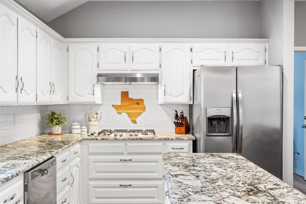 2302 Randi Road Rowlett, TX 75088 - Photo 12 of 33 a kitchen with stainless steel appliances granite countertop a sink and refrigerator