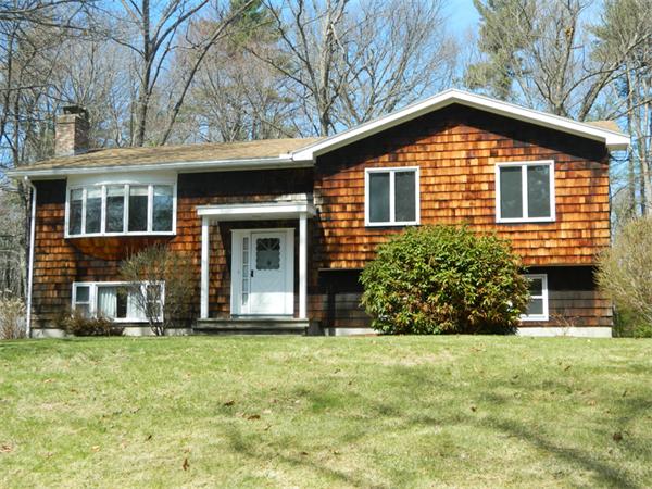 85 Wildwood Road Lunenburg, MA 01462 - Photo 1 of 15 a front view of a house with a yard