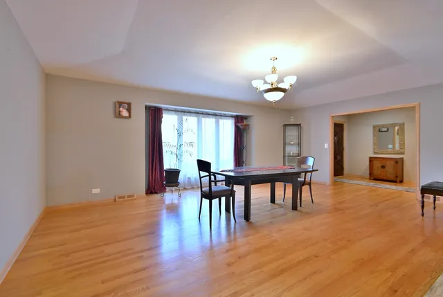 a living room with furniture kitchen view and a large window