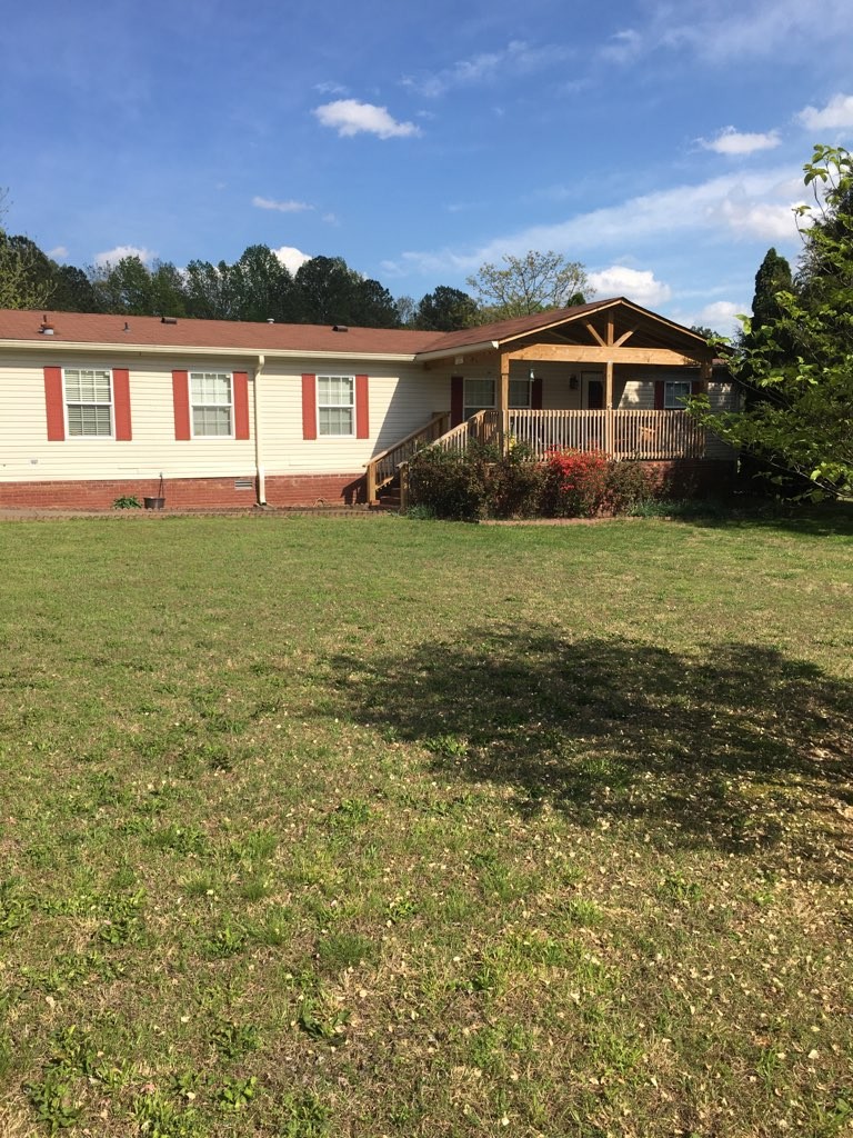 97 North Howard Fitch Road Kelso, TN 37348 - Photo 1 of 30 a front view of a house with a garden