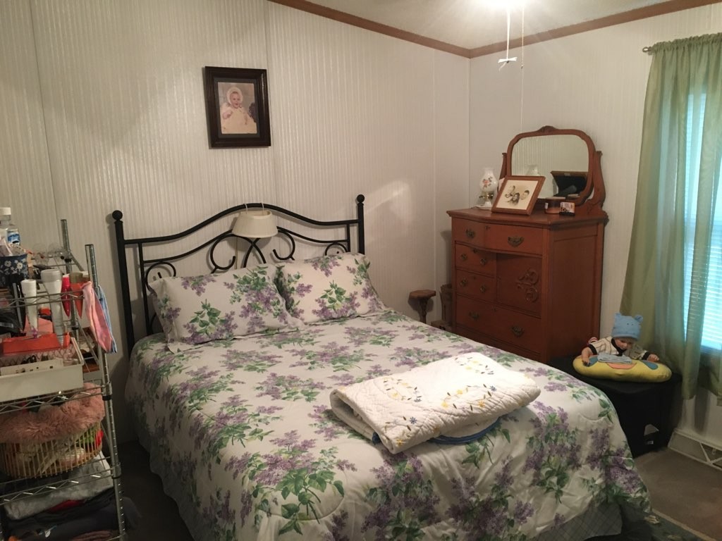 97 North Howard Fitch Road Kelso, TN 37348 - Photo 24 of 30 a large bed sitting in a bedroom next to a window