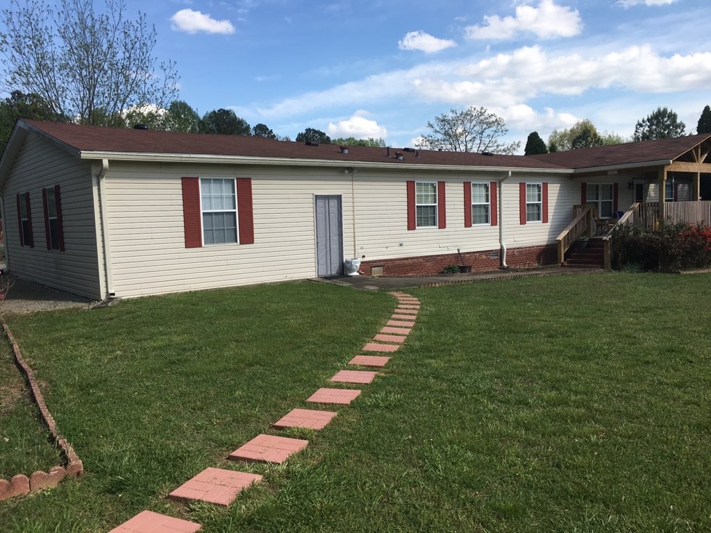 97 North Howard Fitch Road Kelso, TN 37348 - Photo 3 of 30 a front view of a house with a garden