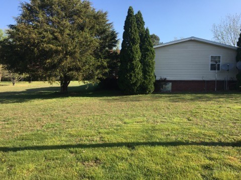 97 North Howard Fitch Road Kelso, TN 37348 - Photo 7 of 30 a view of a large pool with lawn chairs under an umbrella