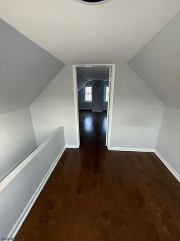 a view of an empty room and wooden floor