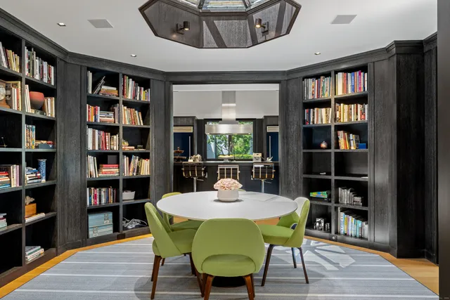 a view of a dining room with furniture and a book shelf