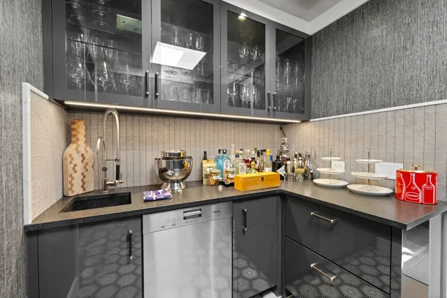 a kitchen with granite countertop lots of stainless steel appliances a sink and cabinets