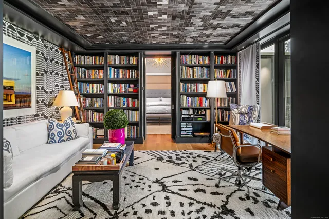 a reading room with furniture and book shelf