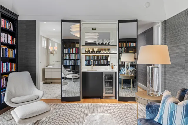 a living room with furniture and a book shelf