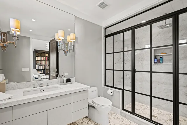 a bathroom with a double vanity sink toilet and a mirror