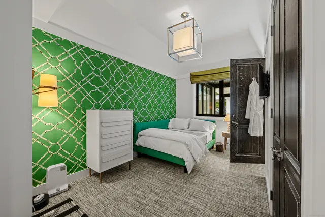 a bedroom with a bed and a painting on the wall