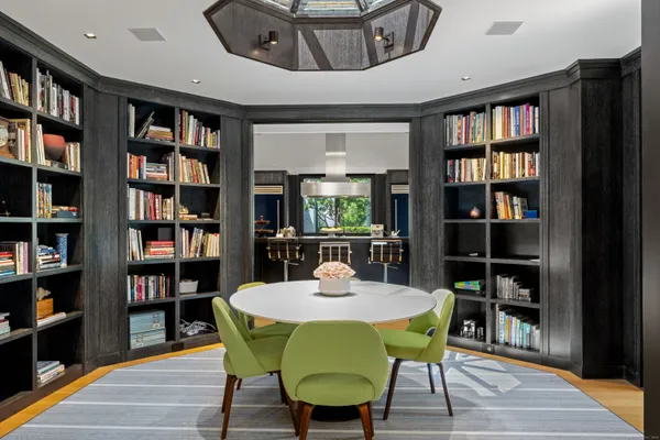 a view of a dining room with furniture and a book shelf