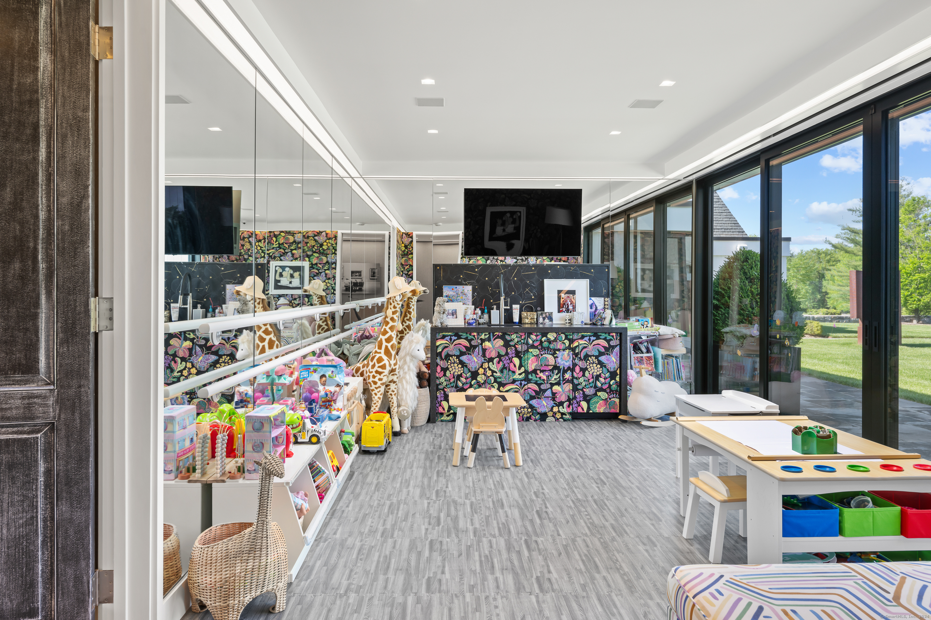 4900 Congress Street Fairfield, CT 06824 - Photo 32 of 40 a living room with furniture and a flat screen tv