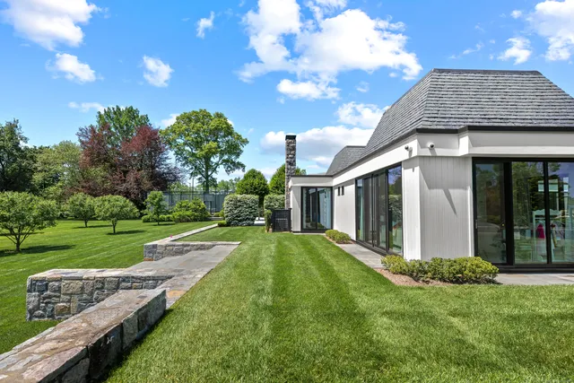 a view of a house with backyard and porch