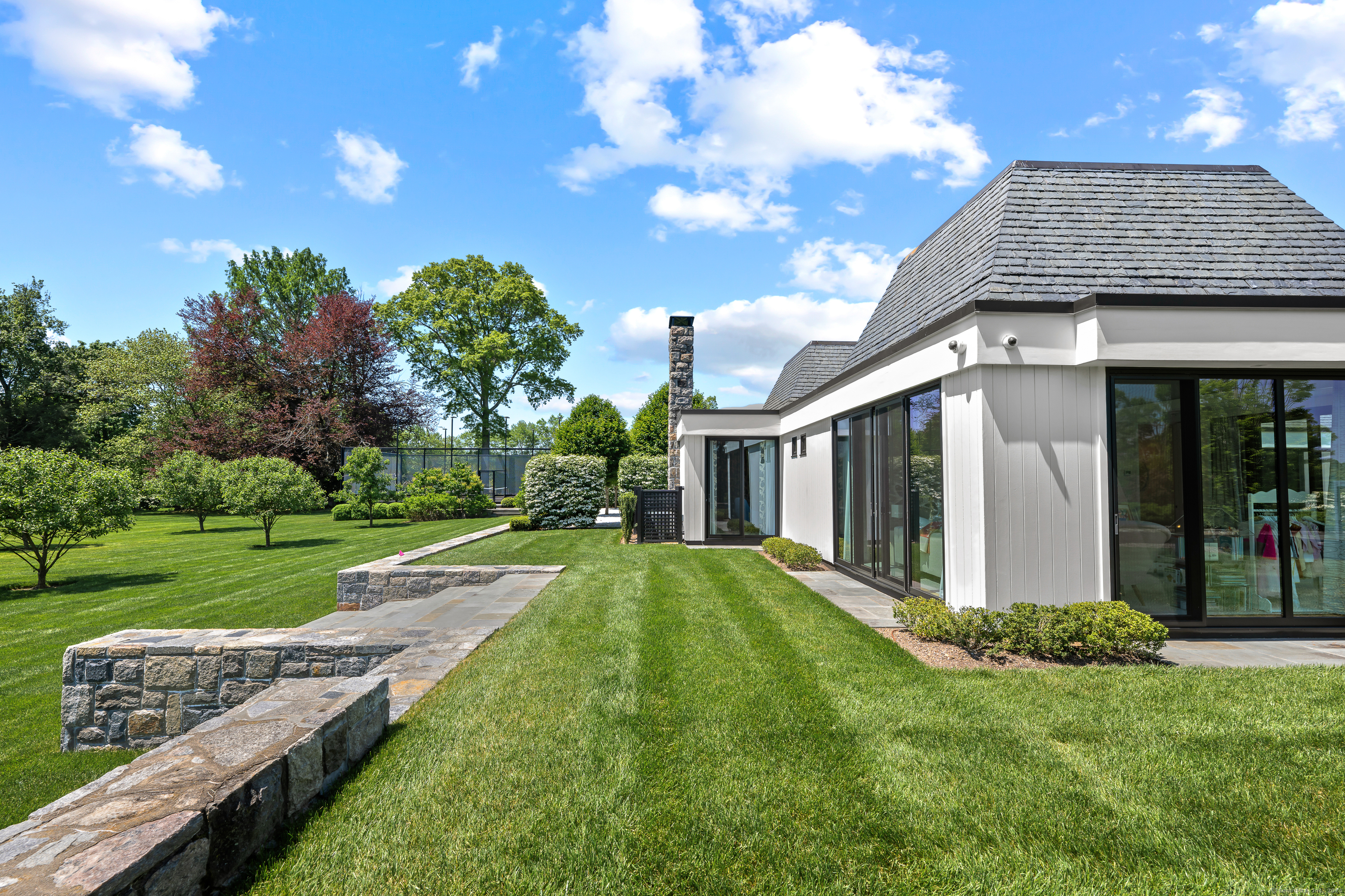 4900 Congress Street Fairfield, CT 06824 - Photo 33 of 40 a view of a house with backyard and porch