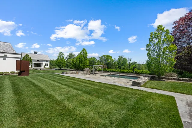 a view of a golf course with a wooden fence