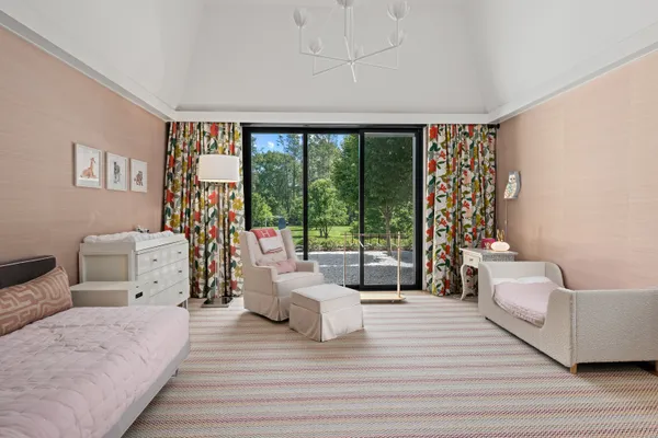 a bedroom with a bed and a large window