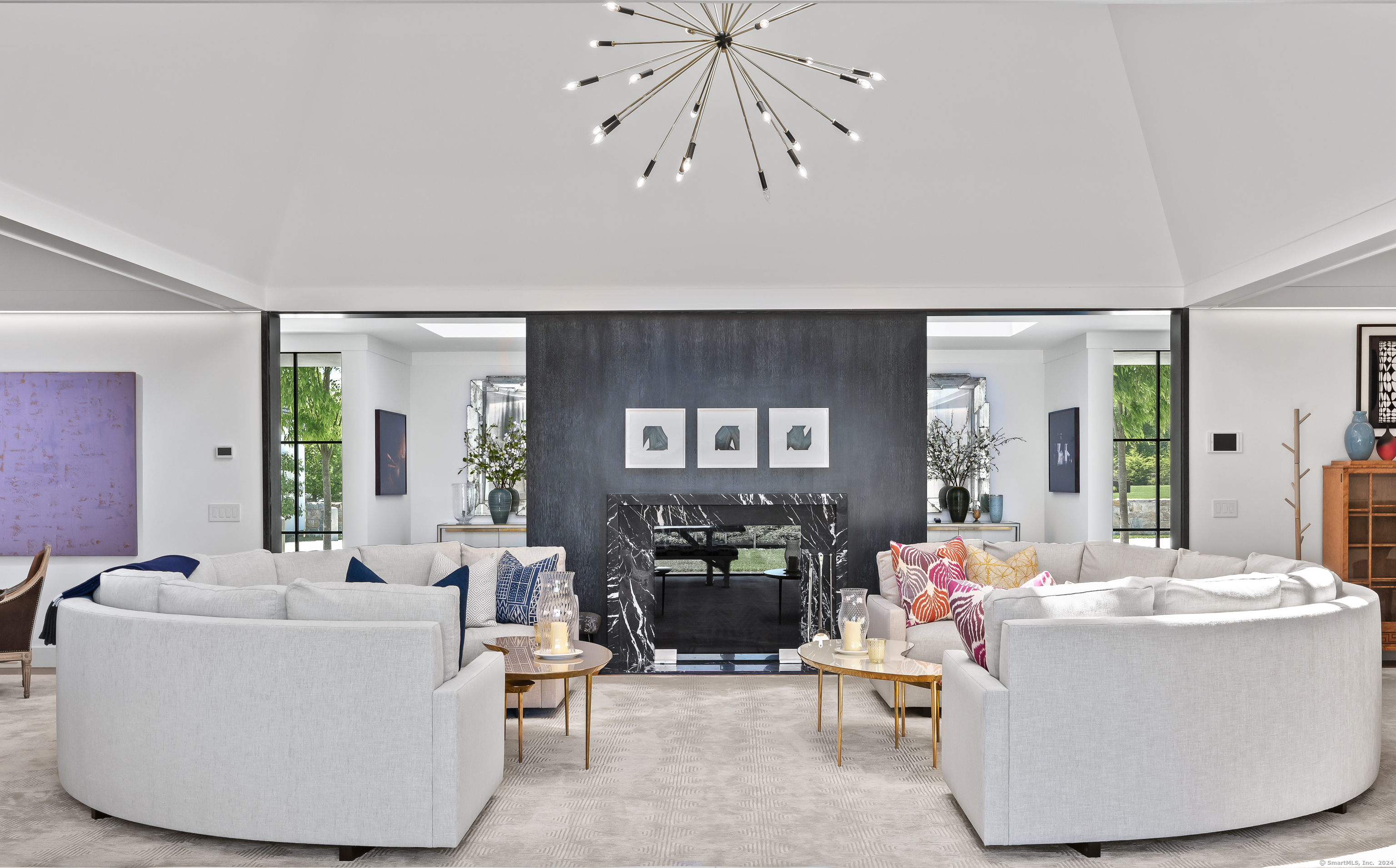 4900 Congress Street Fairfield, CT 06824 - Photo 6 of 40 a living room with couches a fireplace and dining table with wooden floor