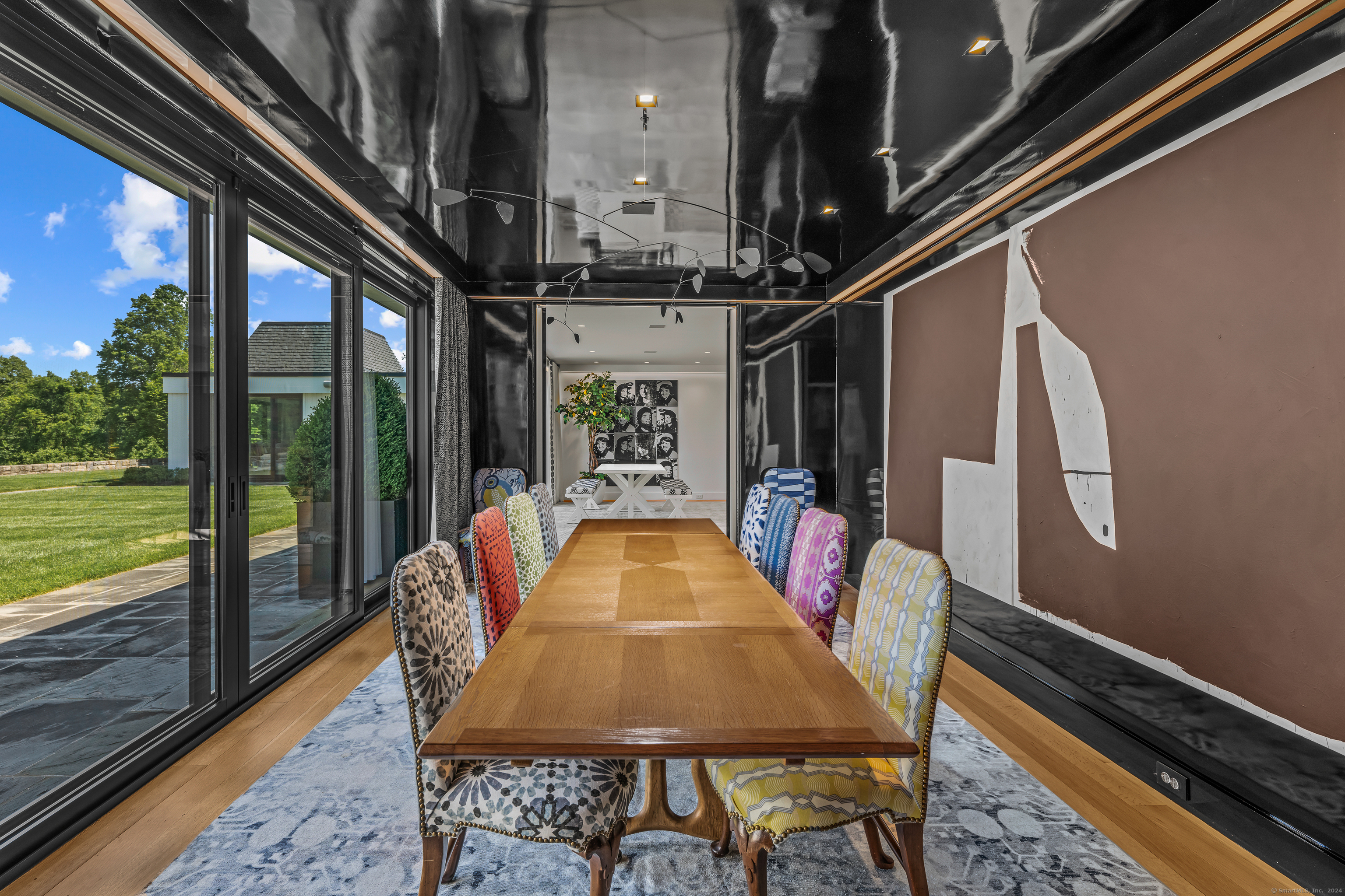 4900 Congress Street Fairfield, CT 06824 - Photo 9 of 40 a dining room with furniture and a floor to ceiling window