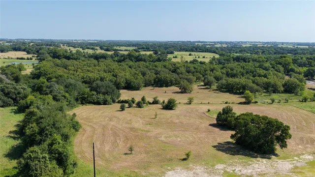 a view of a yard with a wooden fence