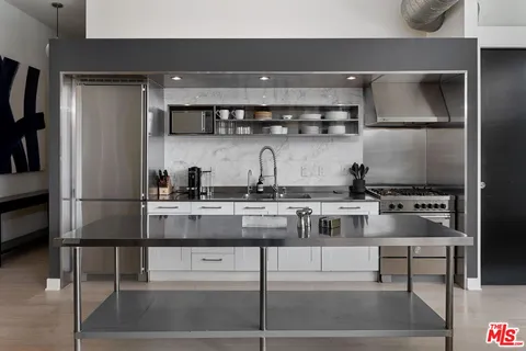 a kitchen with a stove and a refrigerator
