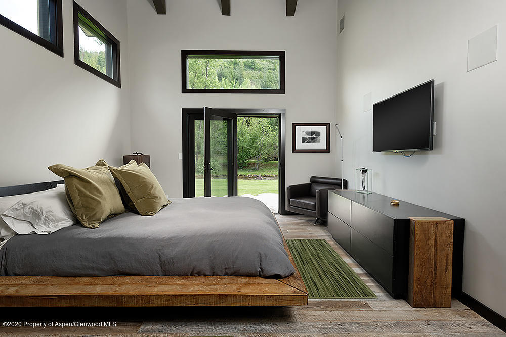 7800 Frying Pan Road Basalt, CO 81621 - Photo 20 of 30 a bedroom with a bed and a flat screen tv