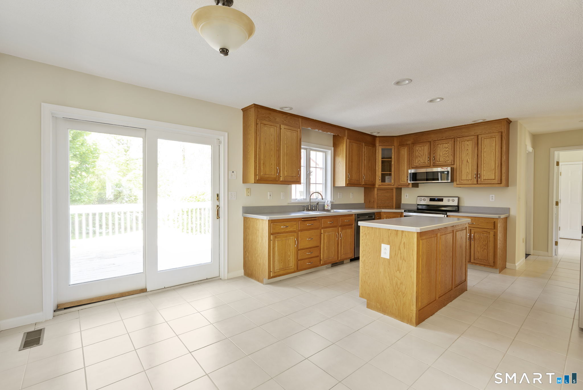 555 Waterville Road Avon, CT 06001 - Photo 26 of 40 a kitchen with granite countertop a stove top oven sink and cabinets