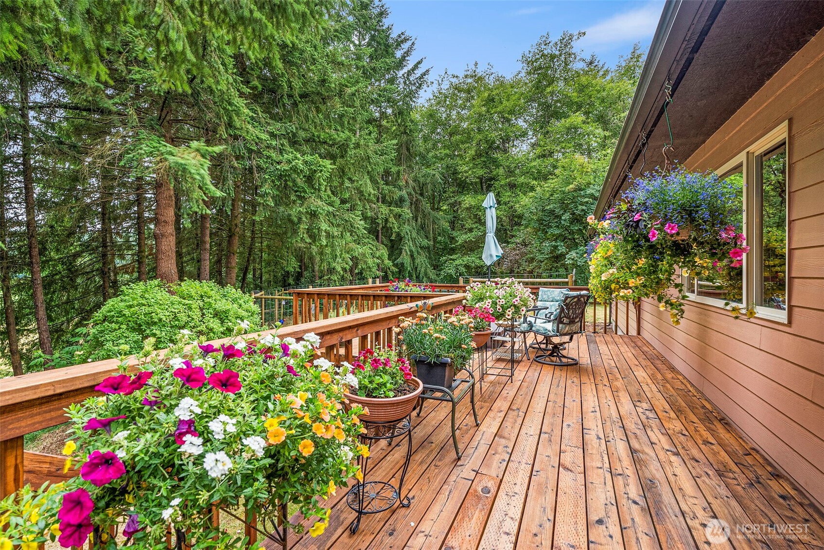 1142 SR 6 Raymond, WA 98577 - Photo 27 of 40 a view of a balcony with lots of flower and trees