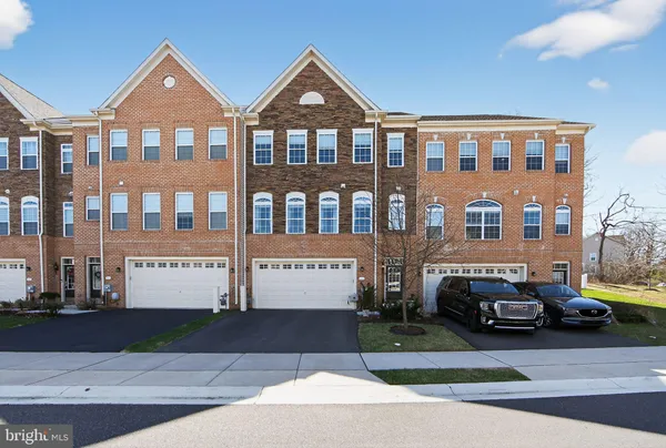a front view of a residential apartment building with a yard