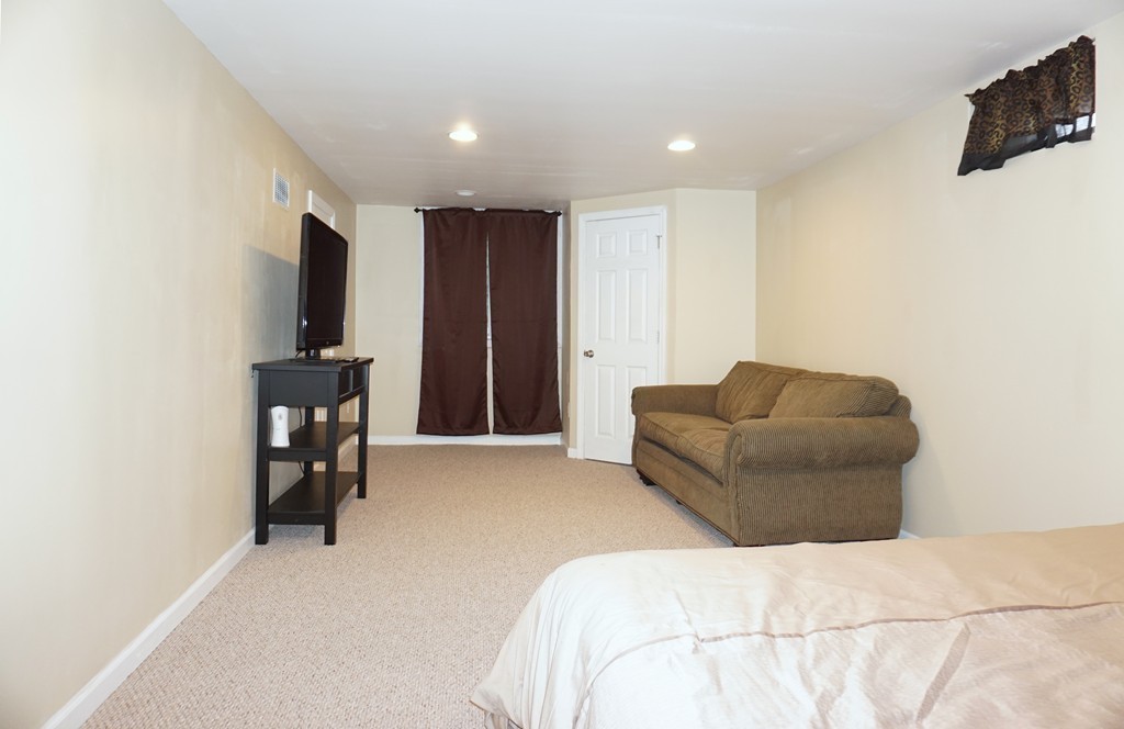 92 Ellendale Circle Springfield, MA 01128 - Photo 21 of 25 a bedroom with furniture and a flat screen tv