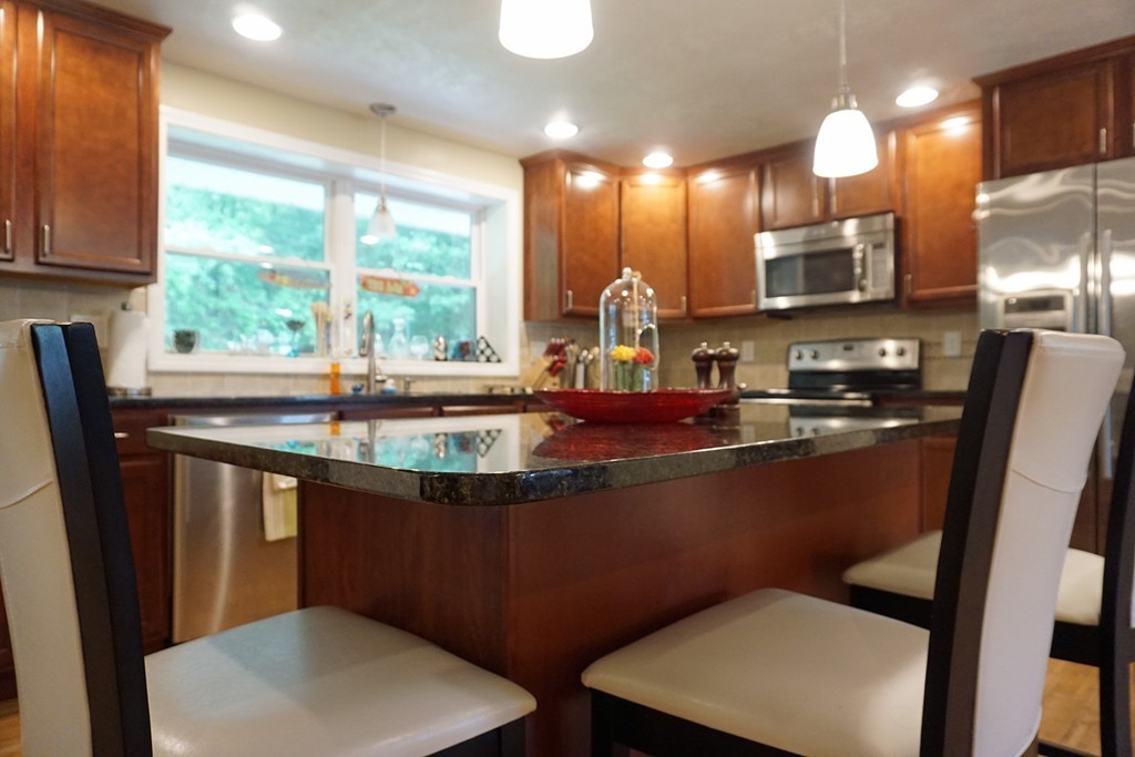 92 Ellendale Circle Springfield, MA 01128 - Photo 8 of 25 a kitchen with stainless steel appliances a sink stove and a refrigerator