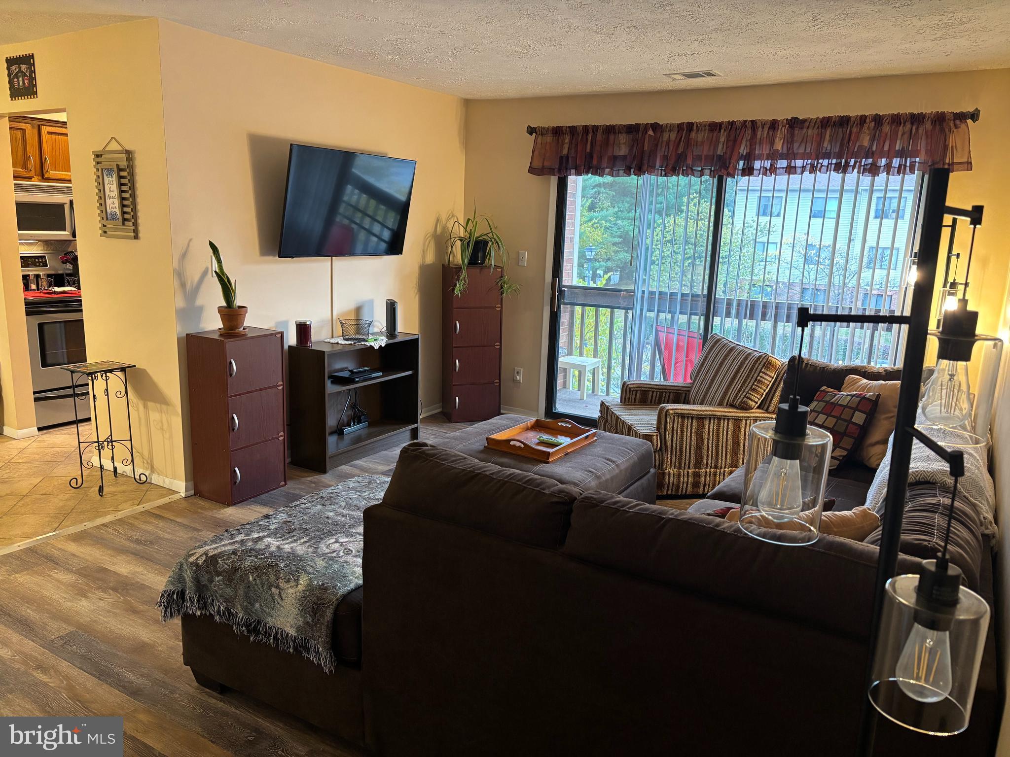 4220 Crystal Court, Unit 3D Hampstead, MD 21074 - Photo 2 of 16 a living room with furniture and a flat screen tv